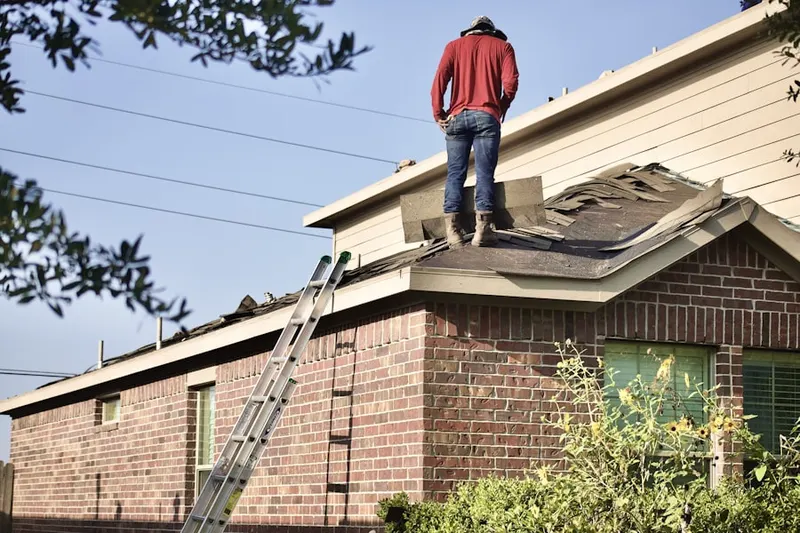 Professional roofer working on a residential roof in Coontown